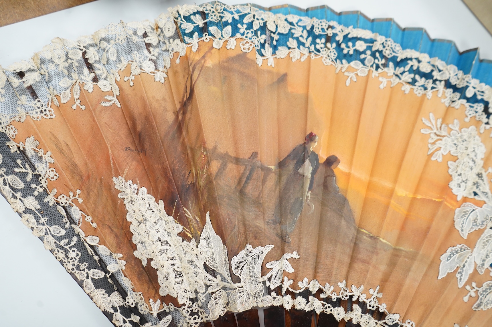 A gold mounted lace and hand painted fan and three others to include a lacquered example, one cased
